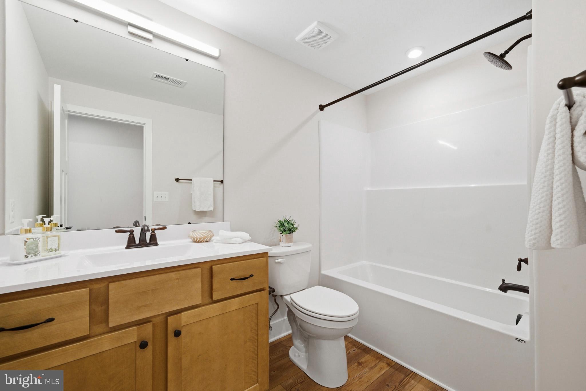 1362 Solomons Island Road Huntingtown, MD 20639 - Photo 33 of 37 a bathroom with a sink a toilet and shower