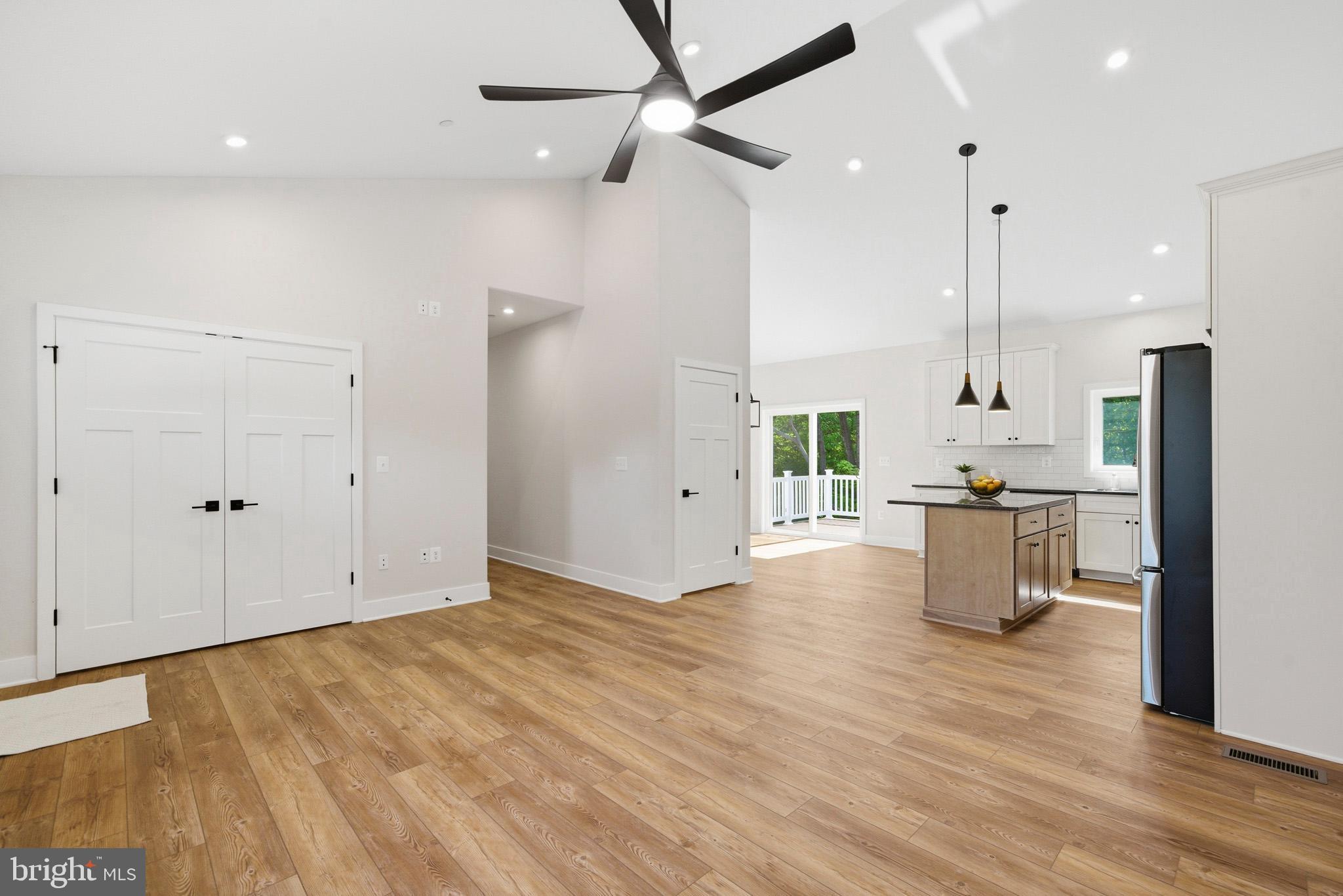 1362 Solomons Island Road Huntingtown, MD 20639 - Photo 9 of 37 an empty room with wooden floor and outdoor view