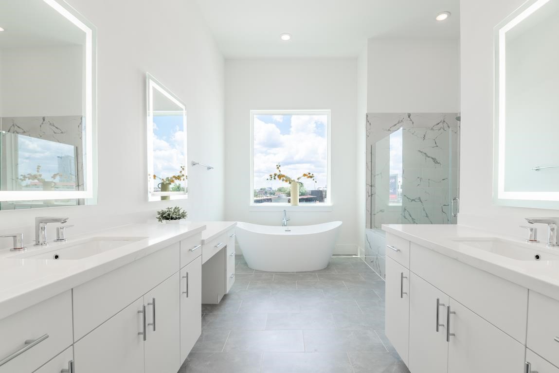 5302 South Capitol Street Houston, TX 77023 - Photo 5 of 10 Primary bath is heaven with wrap around windows on the corner, floating tub and separate vanities. Similar plan and finishes.