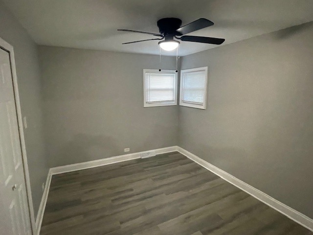 417 Hickory Street, Unit 1 Chicago Heights, IL 60411 - Photo 6 of 7 an empty room with wooden floor chandelier fan and window