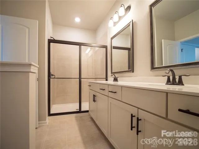 a bathroom with a double vanity sink and mirror