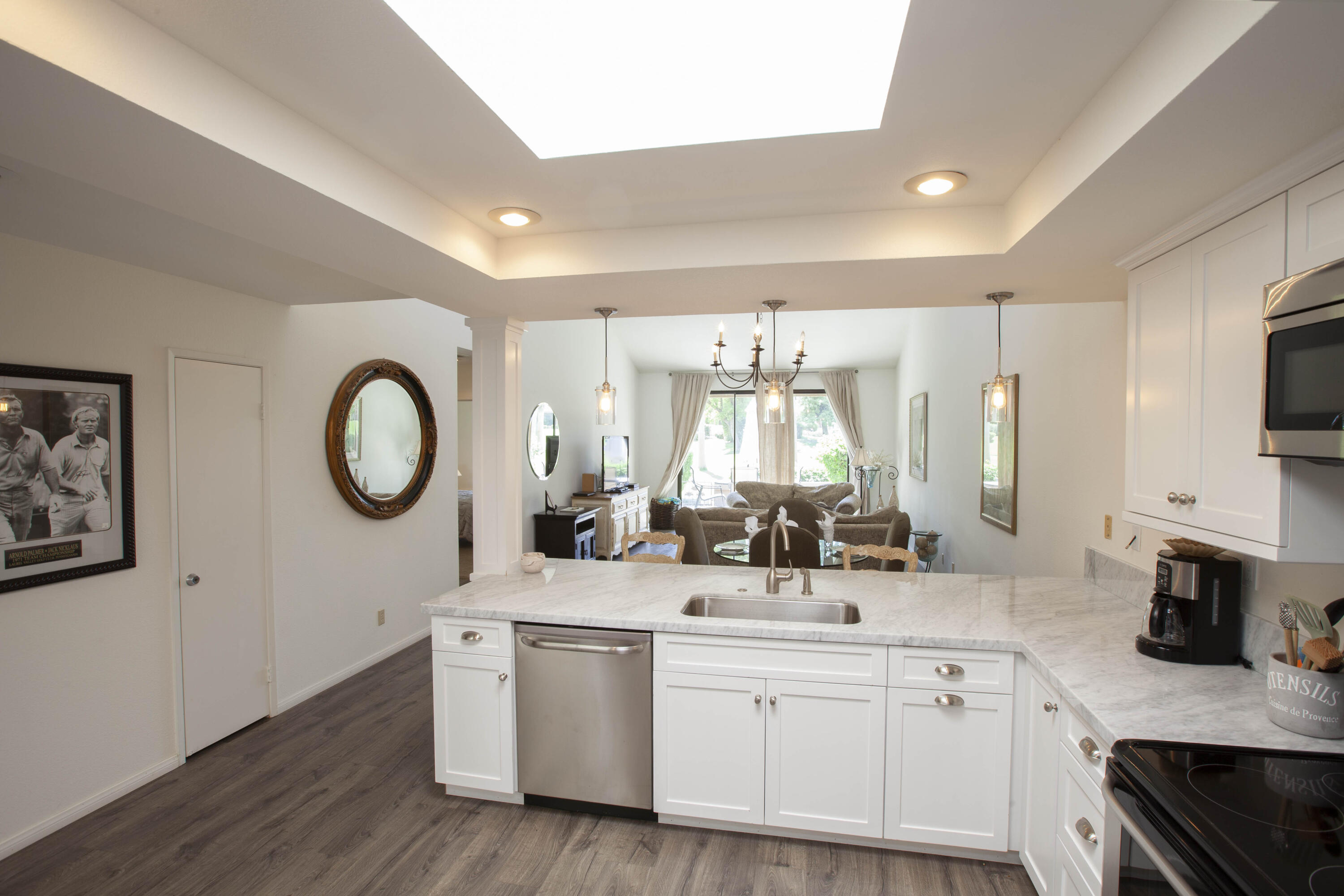 76131 Impatiens Circle Palm Desert, CA 92211 - Photo 1 of 27 a kitchen with white cabinets and sink