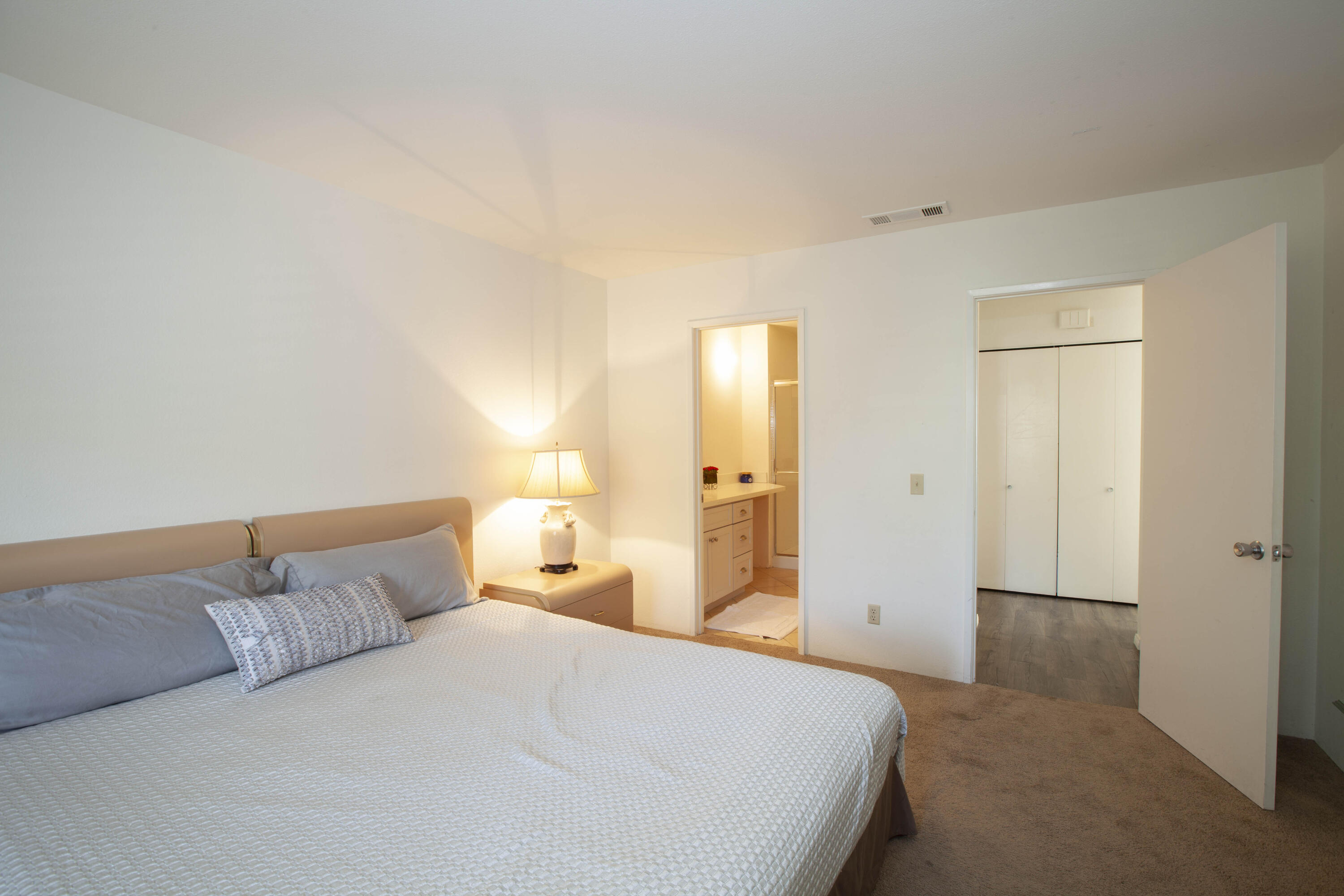 76131 Impatiens Circle Palm Desert, CA 92211 - Photo 12 of 27 a bedroom with a bed and a night stand