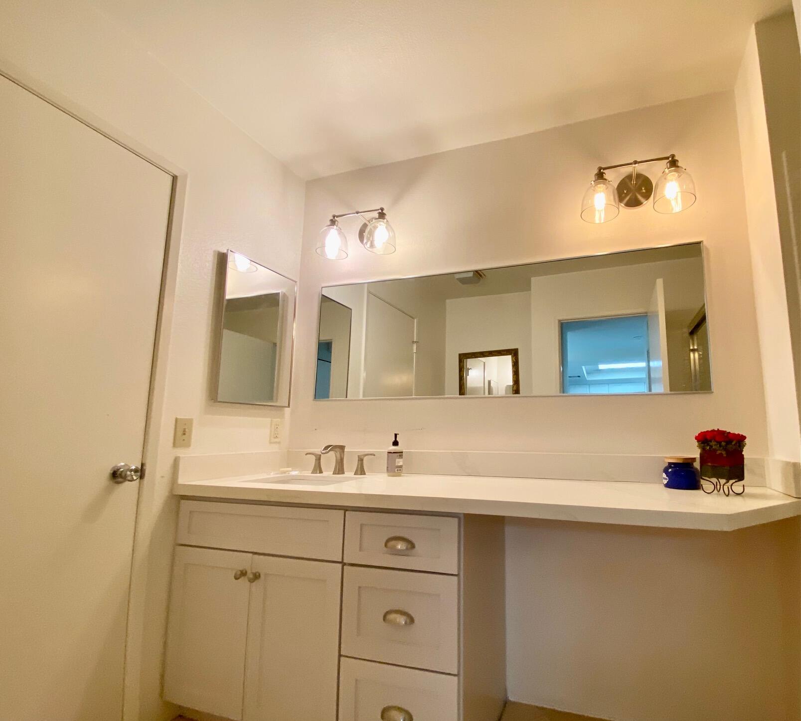 76131 Impatiens Circle Palm Desert, CA 92211 - Photo 15 of 27 a bathroom with a double vanity sink and mirror