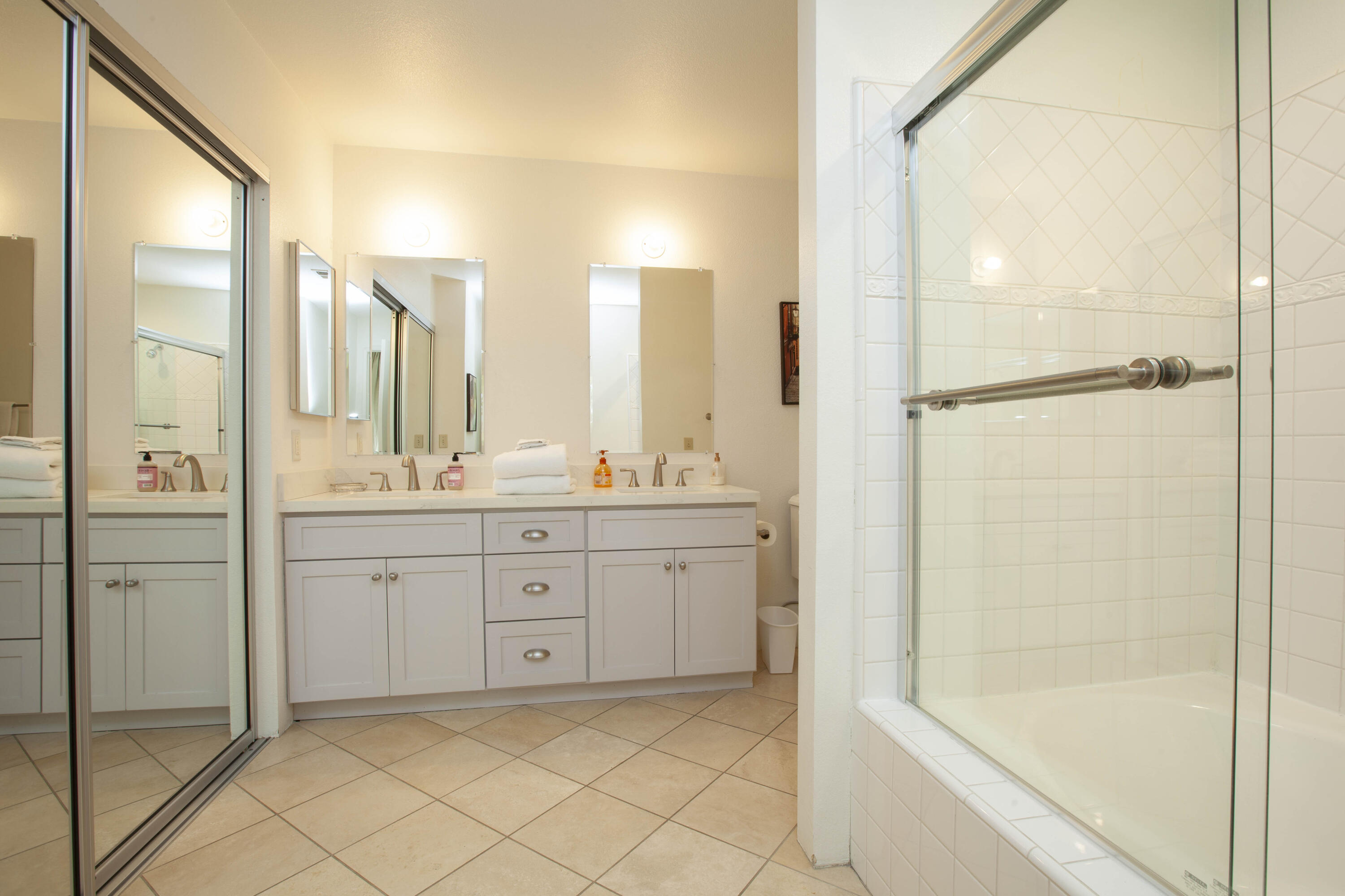 76131 Impatiens Circle Palm Desert, CA 92211 - Photo 19 of 27 a spacious bathroom with a shower a mirror and a sink