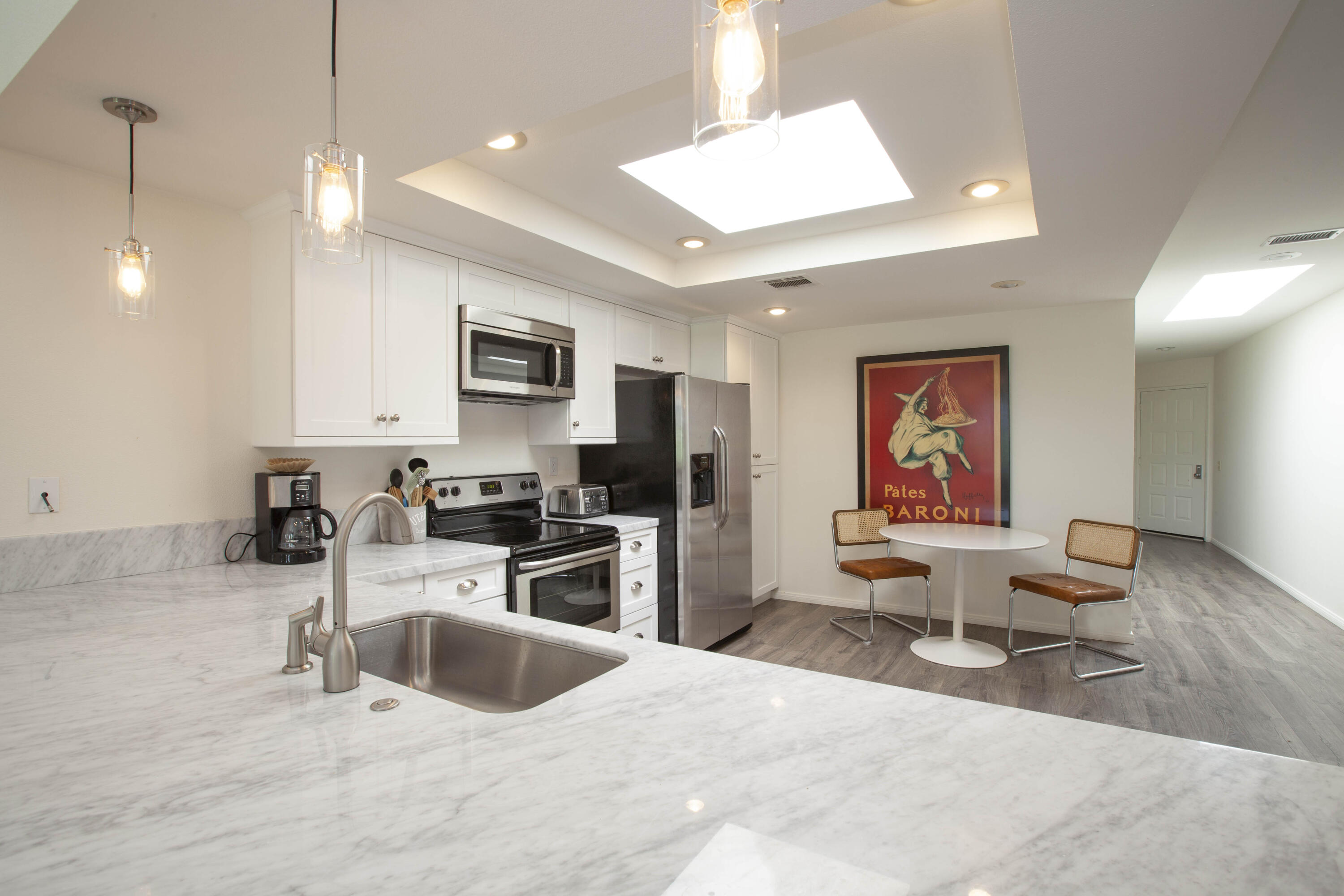 76131 Impatiens Circle Palm Desert, CA 92211 - Photo 7 of 27 a living room with stainless steel appliances kitchen island granite countertop a sink a stove and a refrigerator