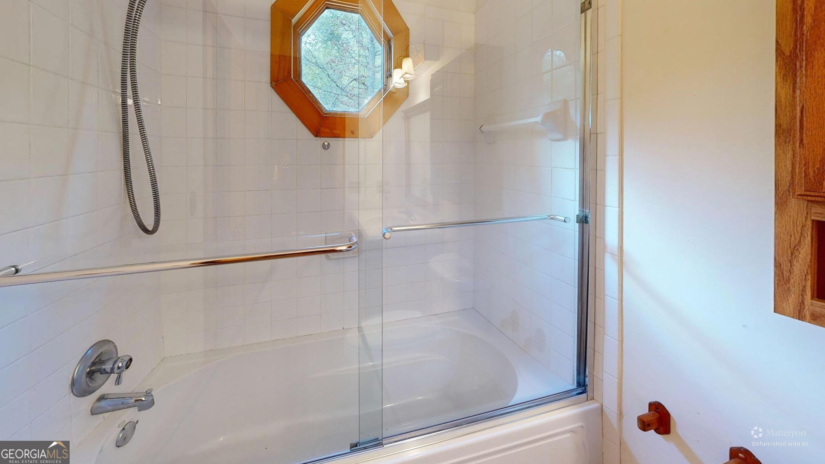 330 Pine Grove Drive Blue Ridge, GA 30513 - Photo 12 of 33 a bathroom with a shower and a mirror