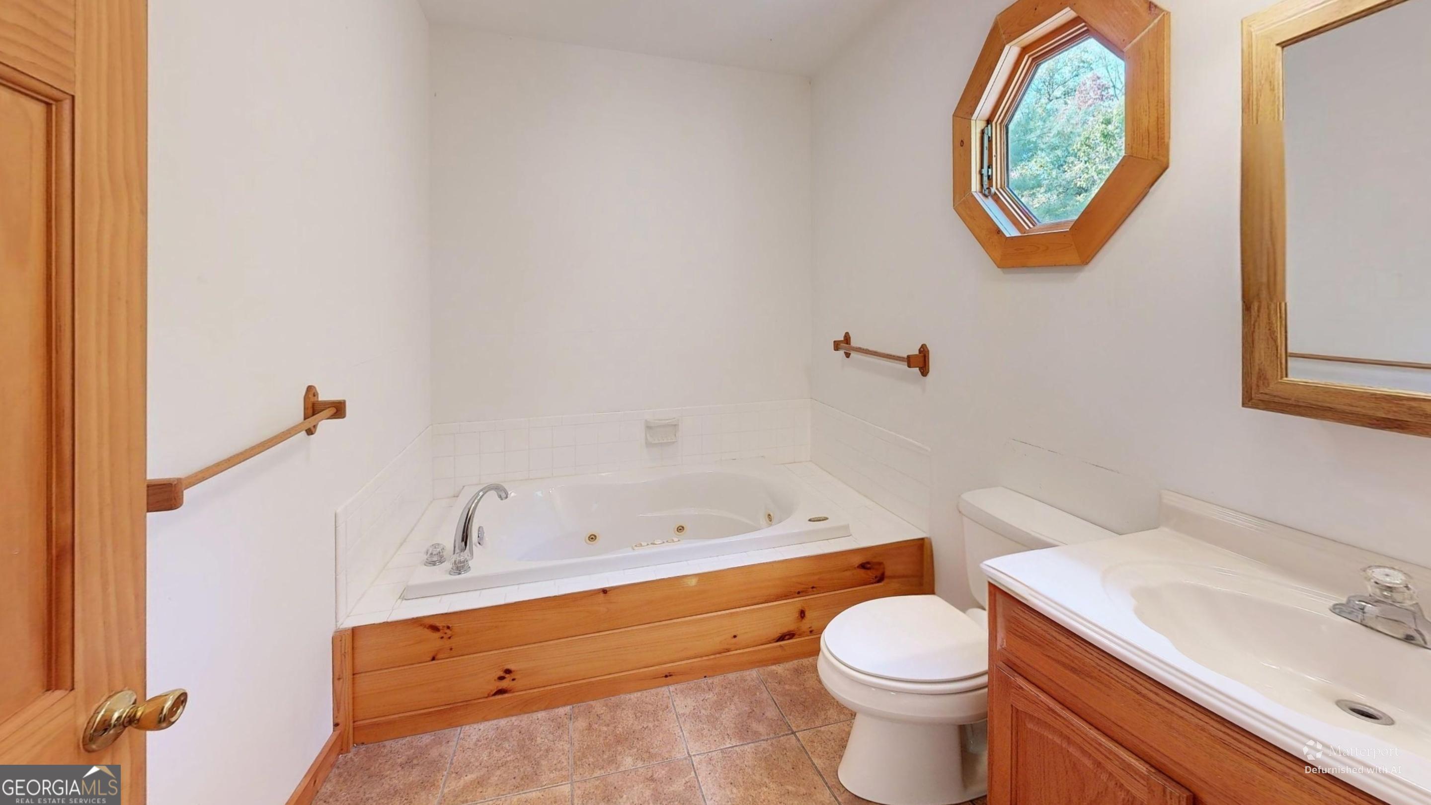 330 Pine Grove Drive Blue Ridge, GA 30513 - Photo 13 of 33 a white toilet sitting next to a bathroom sink