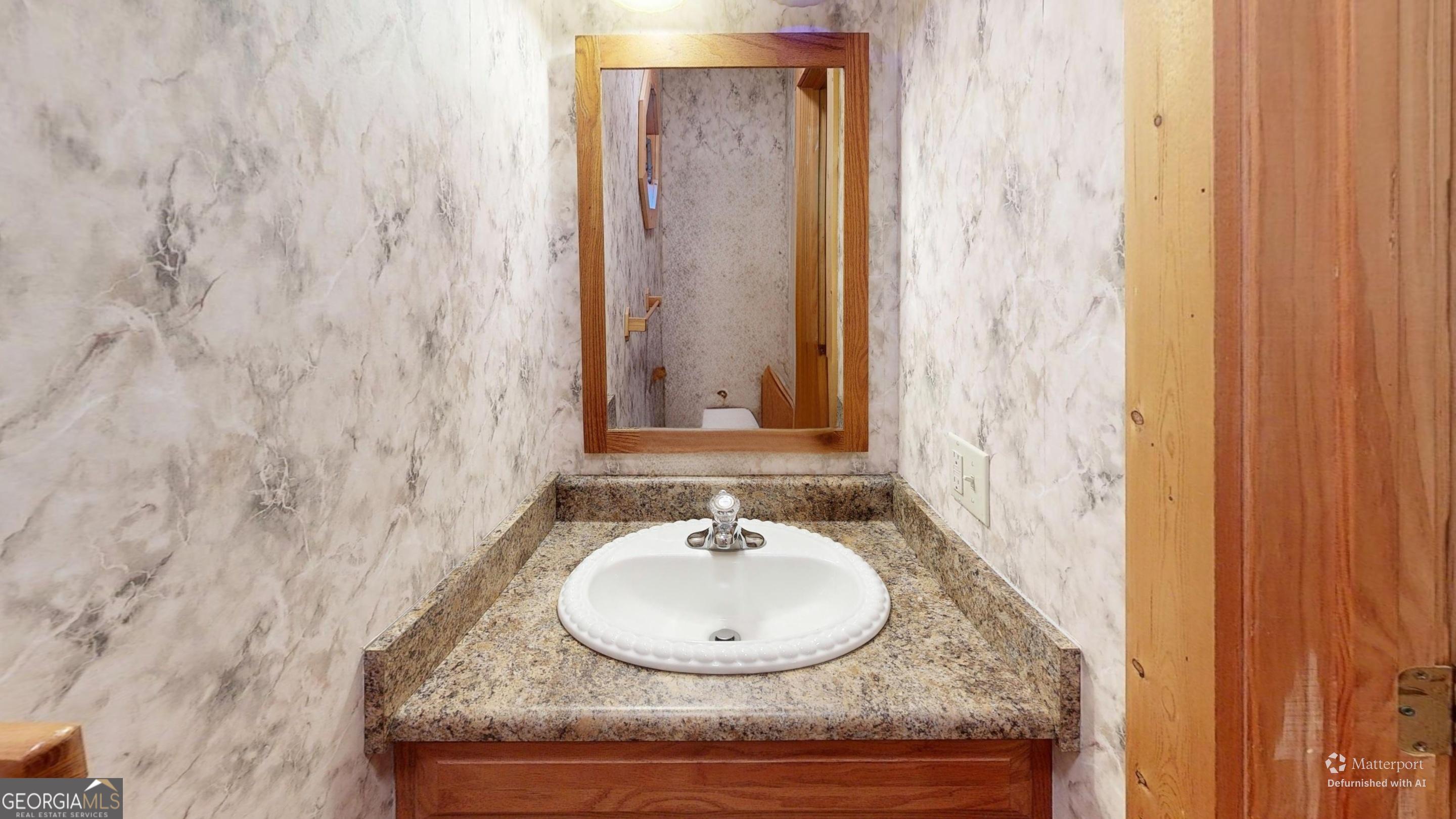 330 Pine Grove Drive Blue Ridge, GA 30513 - Photo 18 of 33 a bathroom with a granite countertop sink and a mirror