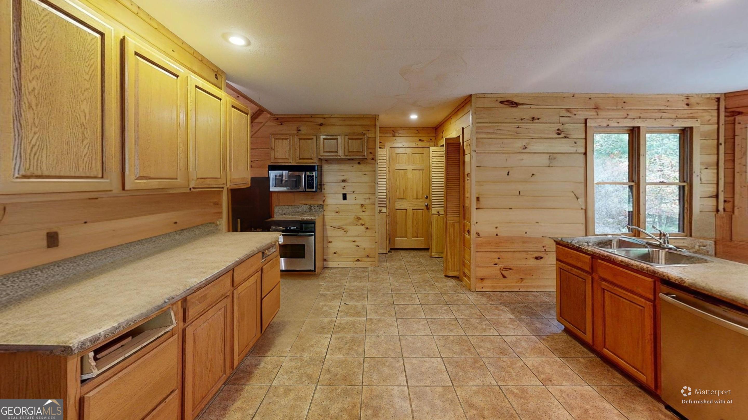 330 Pine Grove Drive Blue Ridge, GA 30513 - Photo 27 of 33 a kitchen with stainless steel appliances kitchen island granite countertop a refrigerator and a stove top oven