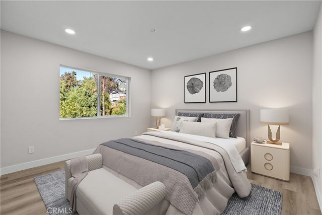 a bedroom with a bed and a painting on the wall