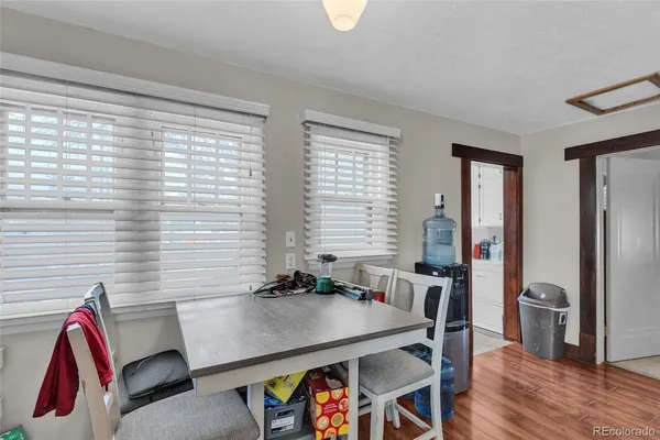 a view of a dining room with furniture and a window