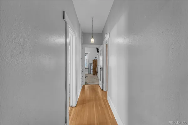 a view of a hallway with wooden floor