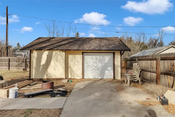 a bedroom with furniture and large windows
