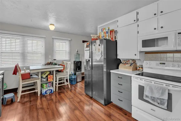 a kitchen with stainless steel appliances a stove top oven and cabinets