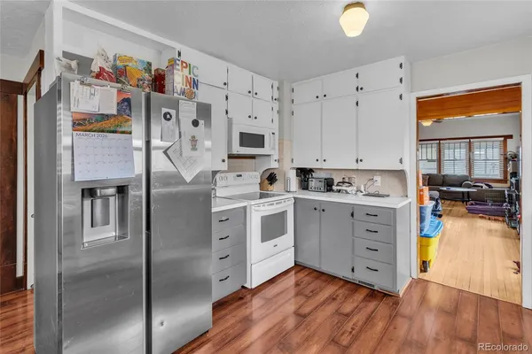 a kitchen with stainless steel appliances a stove top oven a sink and a refrigerator