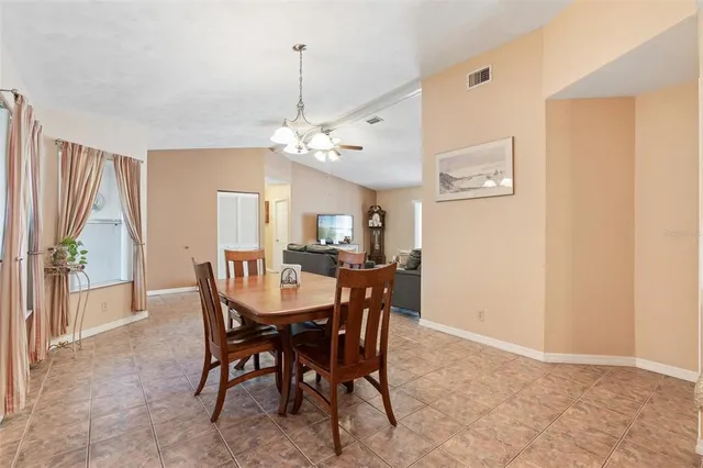 a view of a dining room with furniture and a chandelier