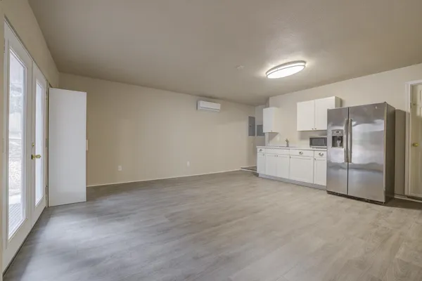 a view of a kitchen with refrigerator and microwave
