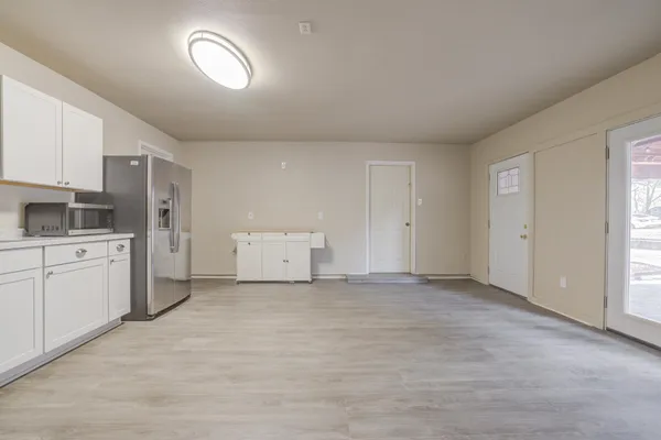a view of a kitchen with a sink and a refrigerator