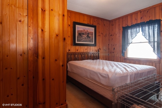 2S337 Dauberman Road Elburn, IL 60119 - Photo 15 of 20 a bed sitting in a bedroom next to a wooden door