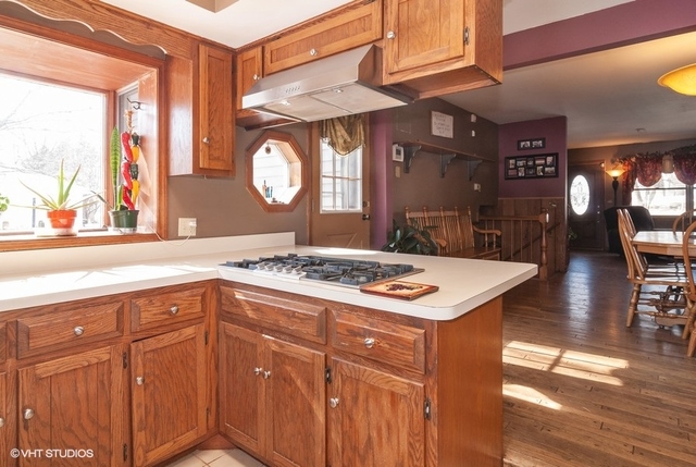 2S337 Dauberman Road Elburn, IL 60119 - Photo 6 of 20 a kitchen with a stove a sink wooden floor and a dining table view