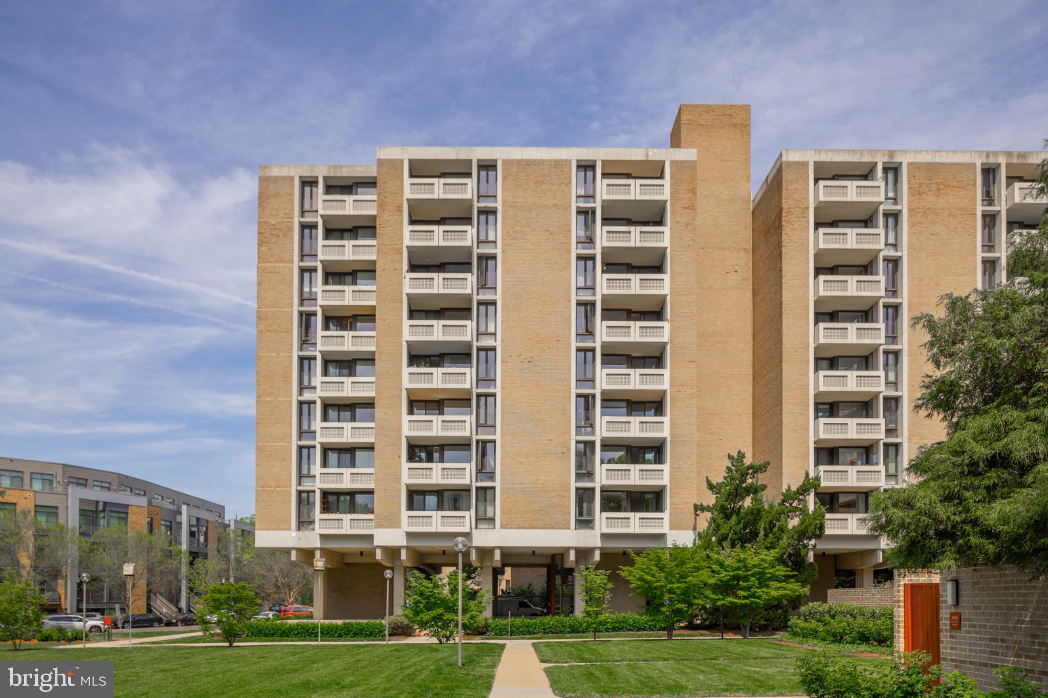 490 M Street Southwest, Unit W101 Washington, DC 20024 - Photo 18 of 26 a front view of a building with a yard