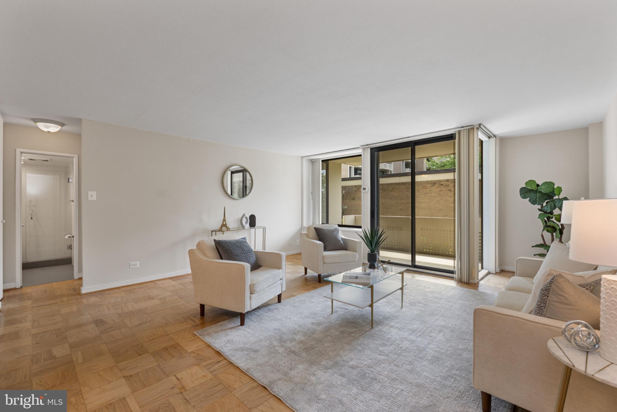 490 M Street Southwest, Unit W101 Washington, DC 20024 - Photo 3 of 26 a living room with furniture and a window