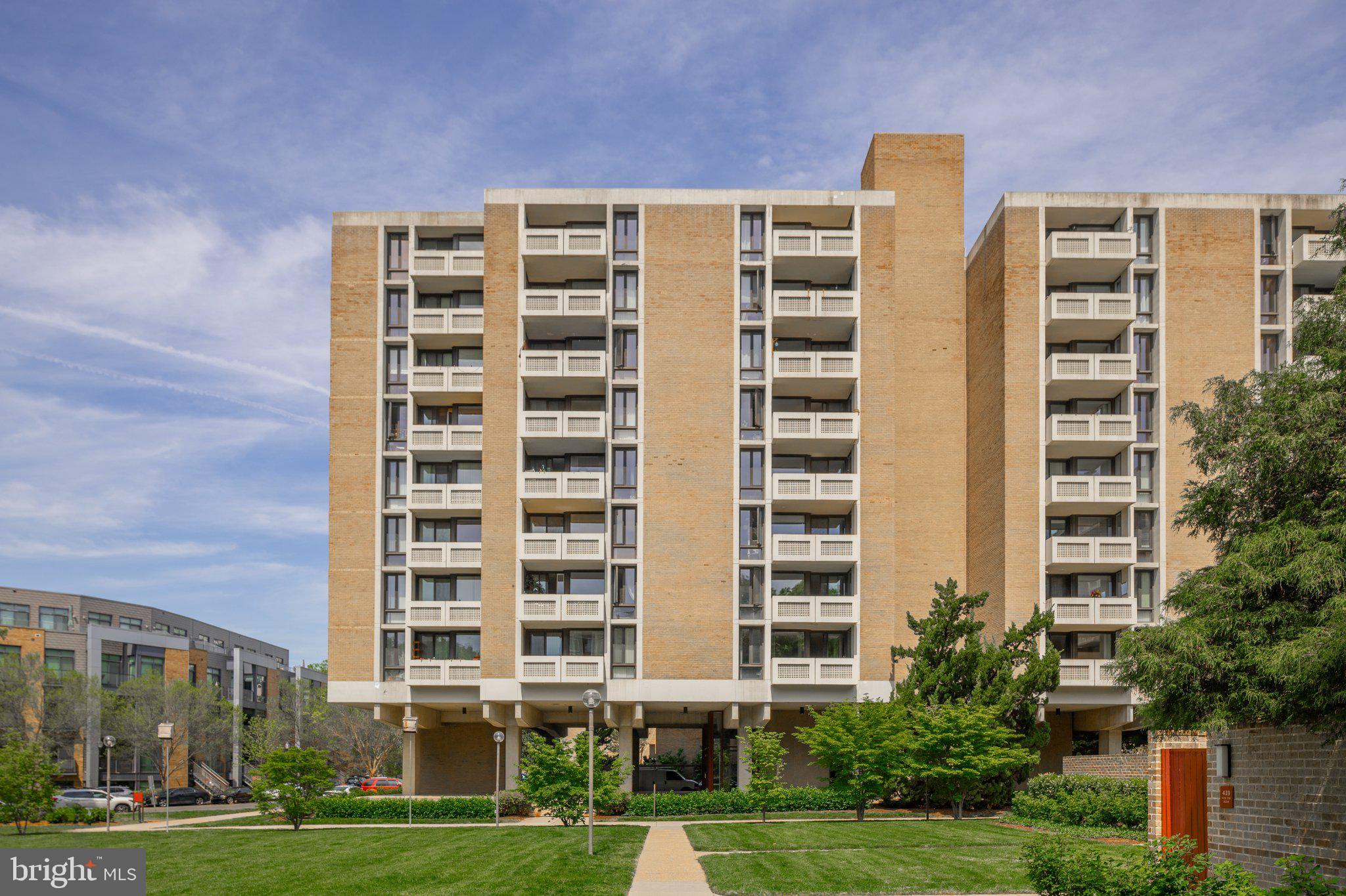 490 M Street Southwest, Unit W101 Washington, DC 20024 - Photo 4 of 26 a front view of a building with a yard