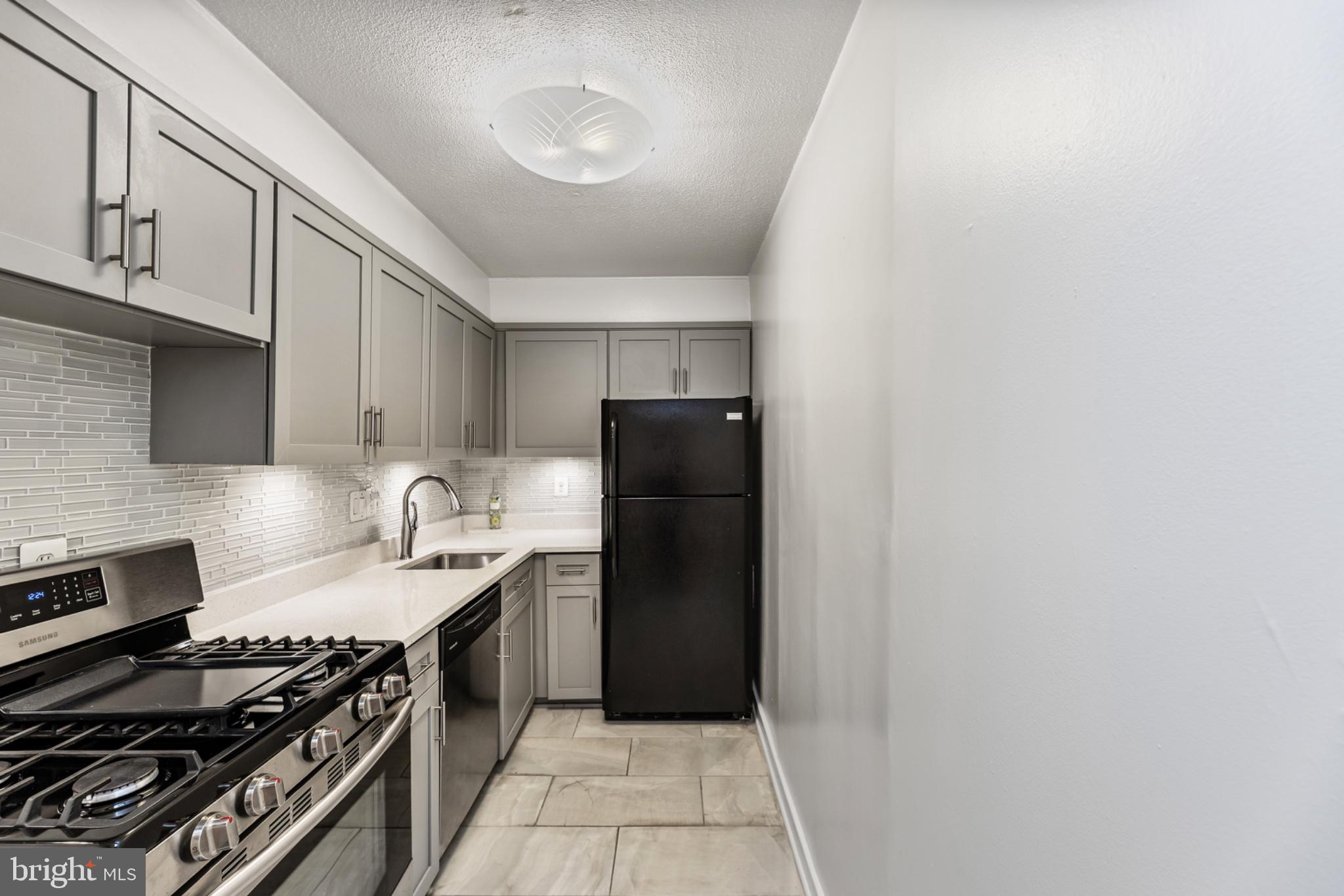 490 M Street Southwest, Unit W101 Washington, DC 20024 - Photo 8 of 26 a kitchen with a stove and a refrigerator