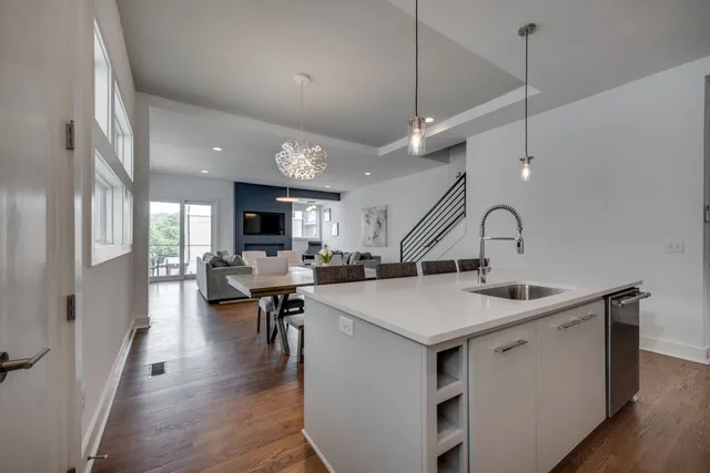 a kitchen with a sink a counter top space and stainless steel appliances