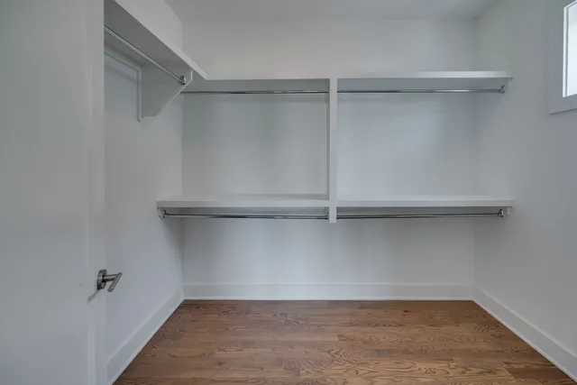 a spacious bedroom with a bed and a chandelier