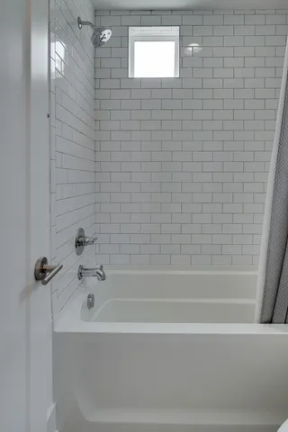 a front view of a house with a yard and green space