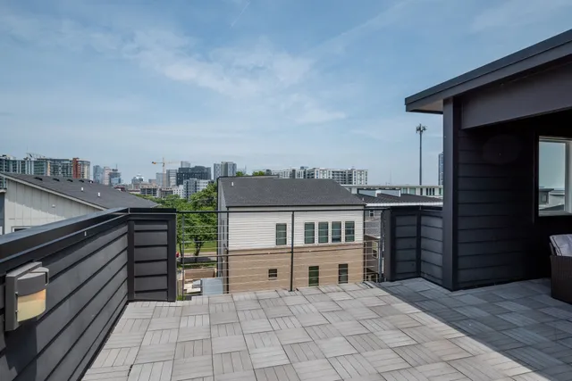 a backyard of a house with table and chairs