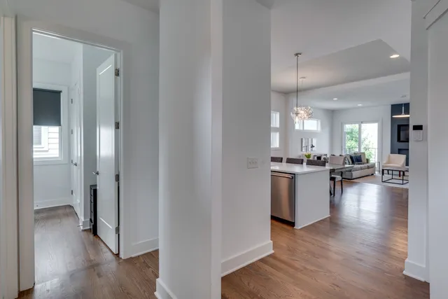 a view of open kitchen with wooden floor and a refrigerator