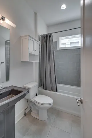 a bathroom with a sink a toilet and a shower