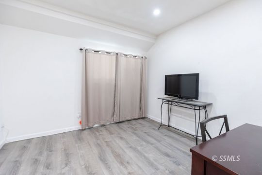400 Tepatitlan Court Ridgecrest, CA 93555 - Photo 30 of 35 a living room with furniture and a flat screen tv
