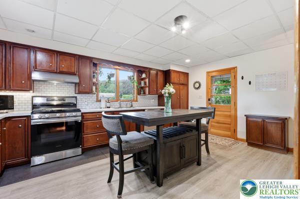 2021 Leithsville Road Hellertown, PA 18055 - Photo 11 of 39 A well-appointed kitchen featuring rich wood cabinetry, stainless-steel appliances, & new LVP flooring.