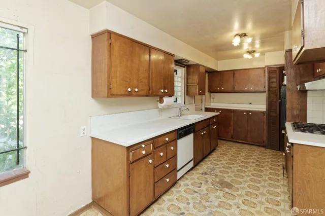 a kitchen with a sink cabinets and window