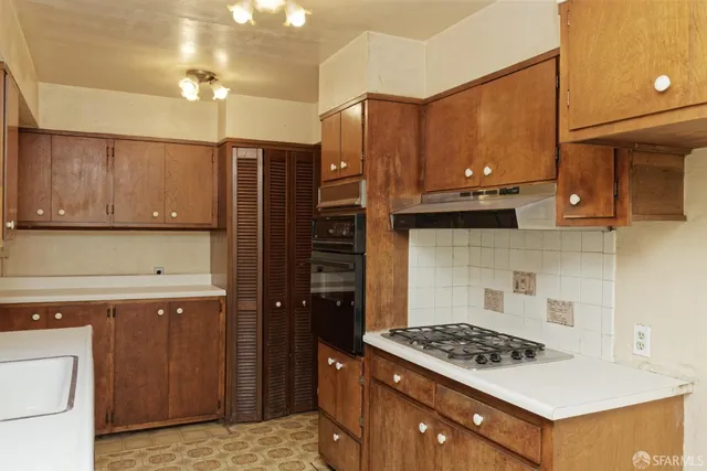a kitchen with stainless steel appliances granite countertop a stove a refrigerator and a cabinets