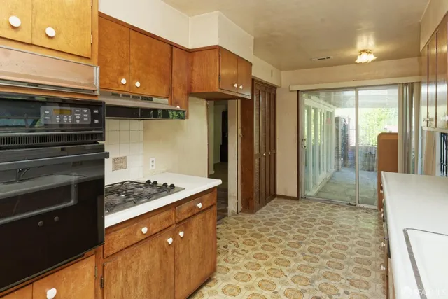 a kitchen with stainless steel appliances granite countertop a stove a refrigerator and a sink