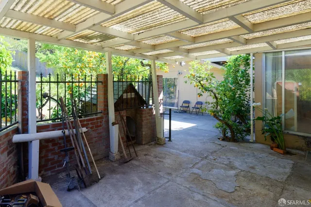 a view of a porch with furniture and a yard