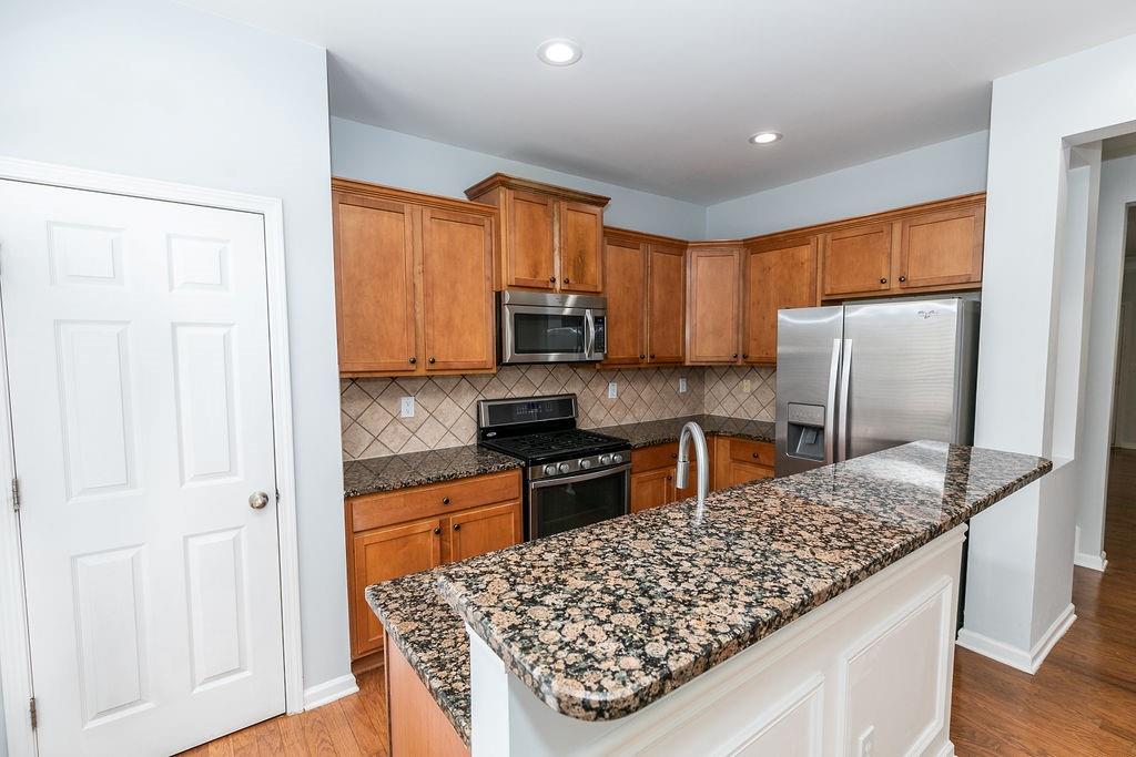 827 Charles Bank Avenue Southeast, Unit 827 Atlanta, GA 30312 - Photo 11 of 45 a kitchen with stainless steel appliances granite countertop a refrigerator oven stove sink and cabinets