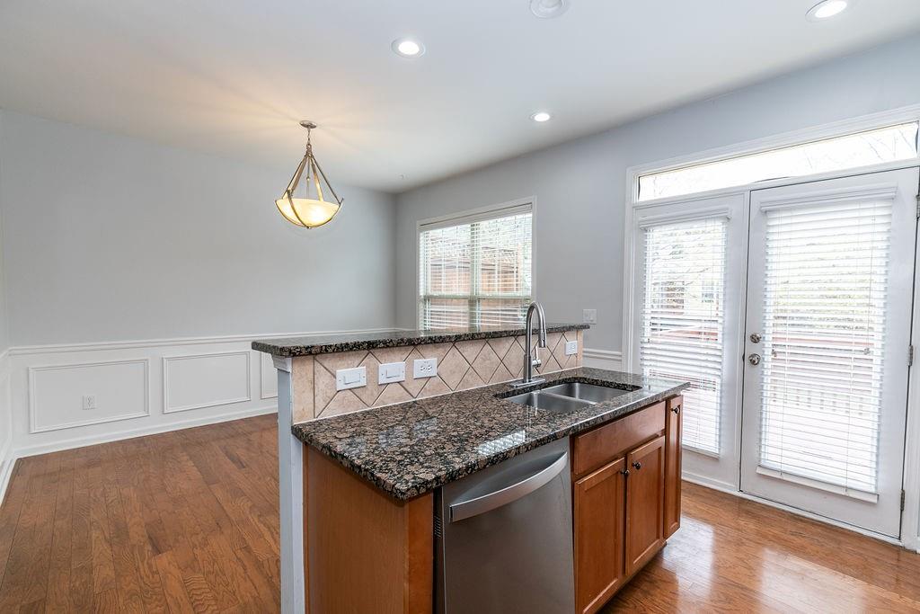 827 Charles Bank Avenue Southeast, Unit 827 Atlanta, GA 30312 - Photo 13 of 45 a kitchen with granite countertop sink stove and cabinets