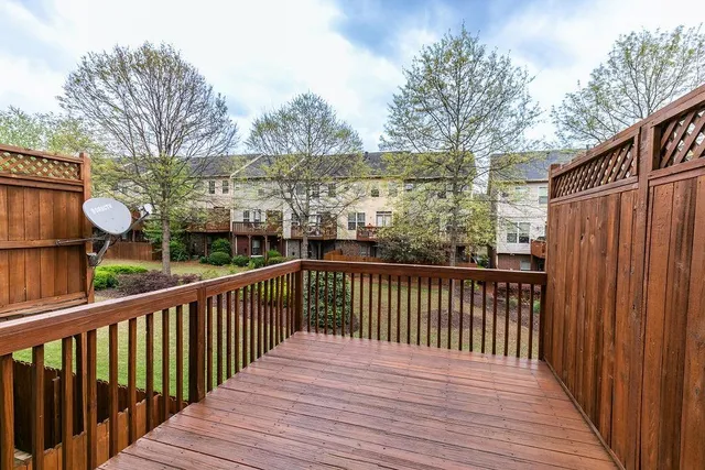a view of a street with wooden fence