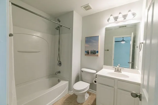 a bathroom with a shower curtain and a window