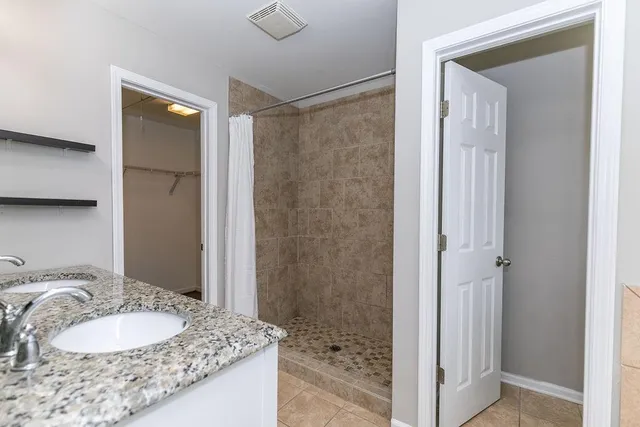a white bath tub sitting next to a toilet
