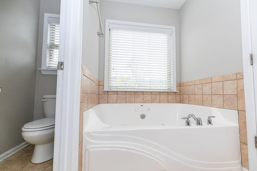 827 Charles Bank Avenue Southeast, Unit 827 Atlanta, GA 30312 - Photo 33 of 45 a white bath tub sitting next to a toilet