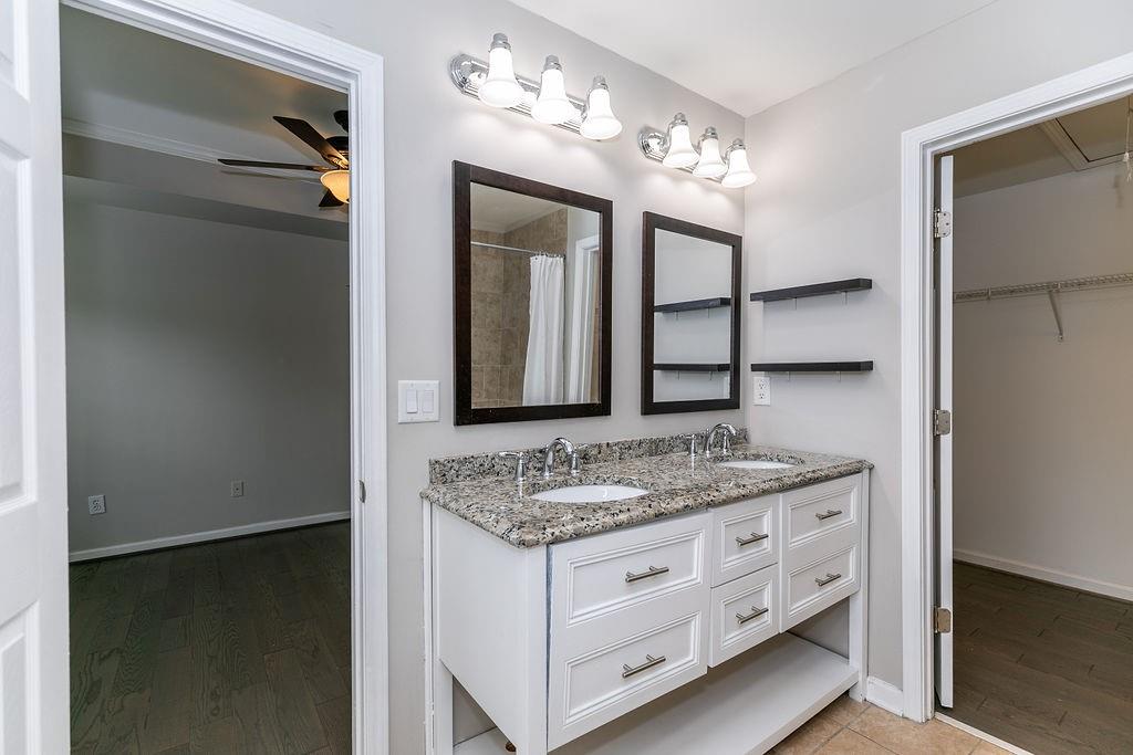 827 Charles Bank Avenue Southeast, Unit 827 Atlanta, GA 30312 - Photo 35 of 45 a bathroom with a granite countertop sink and a mirror