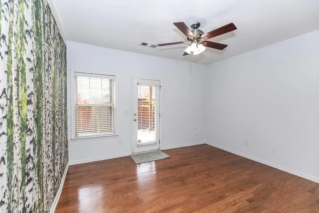 wooden floor in an empty room with a window