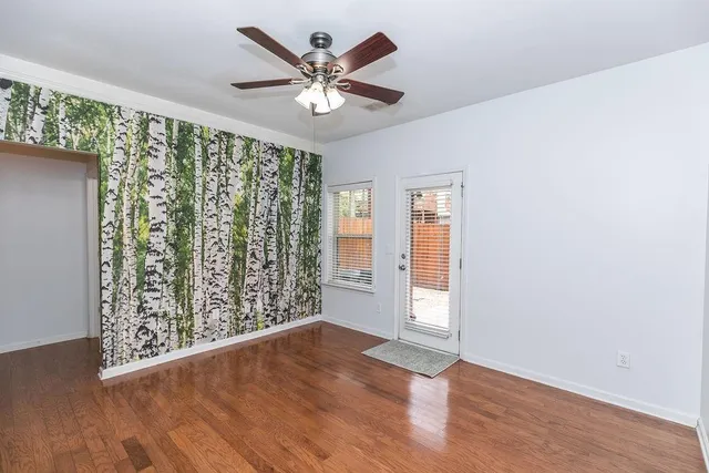 wooden floor in an empty room with a window